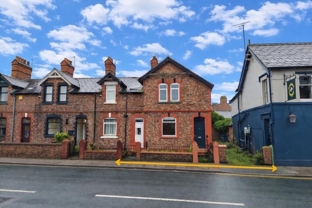 The Lancashire probate property, a red brick terrace beside the neighbouring pub, with the disputed right of way running along the pavement in front
